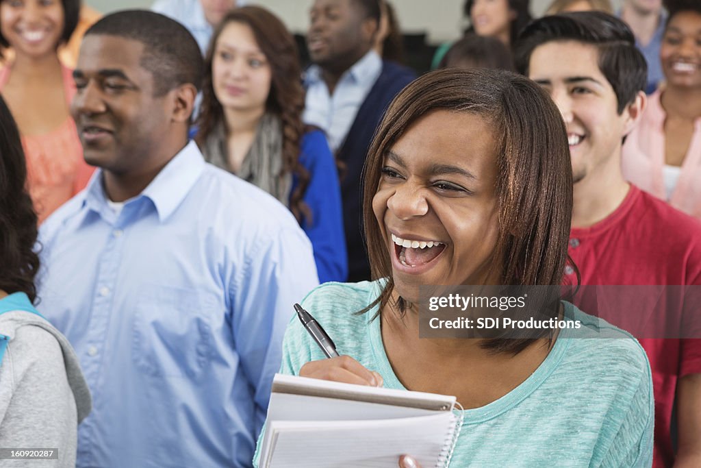 Being Rushed Taking Notes Excited College Student Taking Notes In Crowded Classroom High-Res ...