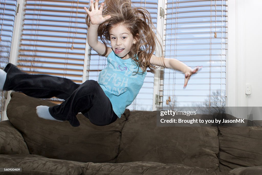 Young Girl Jumping on the Couch