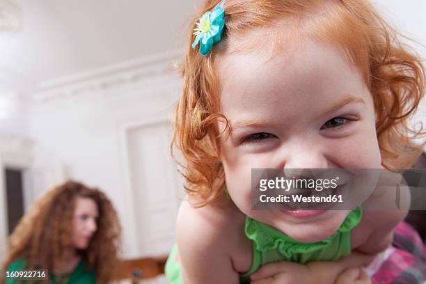 germany, berlin, girl having fun at home, woman in background - girls misbehaving stock pictures, royalty-free photos & images