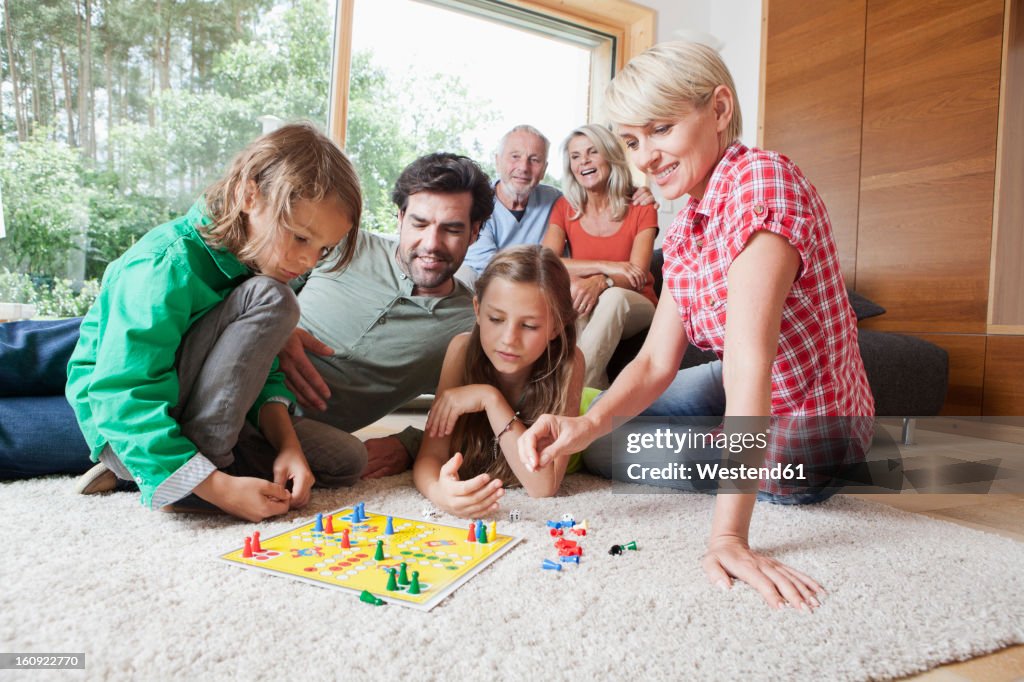 Germany, Bavaria, Nuremberg, Family playing board game together
