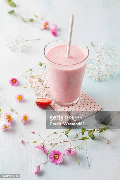 glass of strawberry smoothie with cornflower blossom - batido de fresa fotografías e imágenes de stock