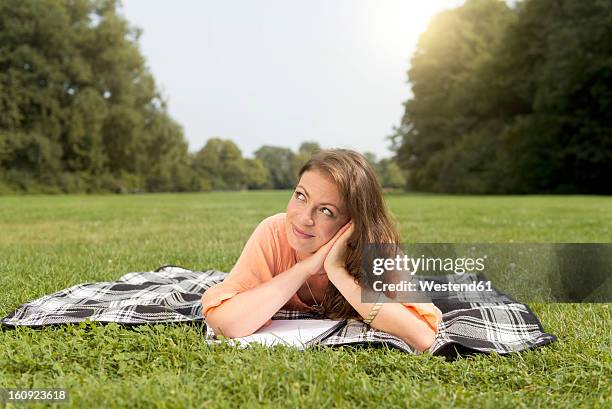 germany, berlin, young student learning in treptower park - treptower park stock pictures, royalty-free photos & images