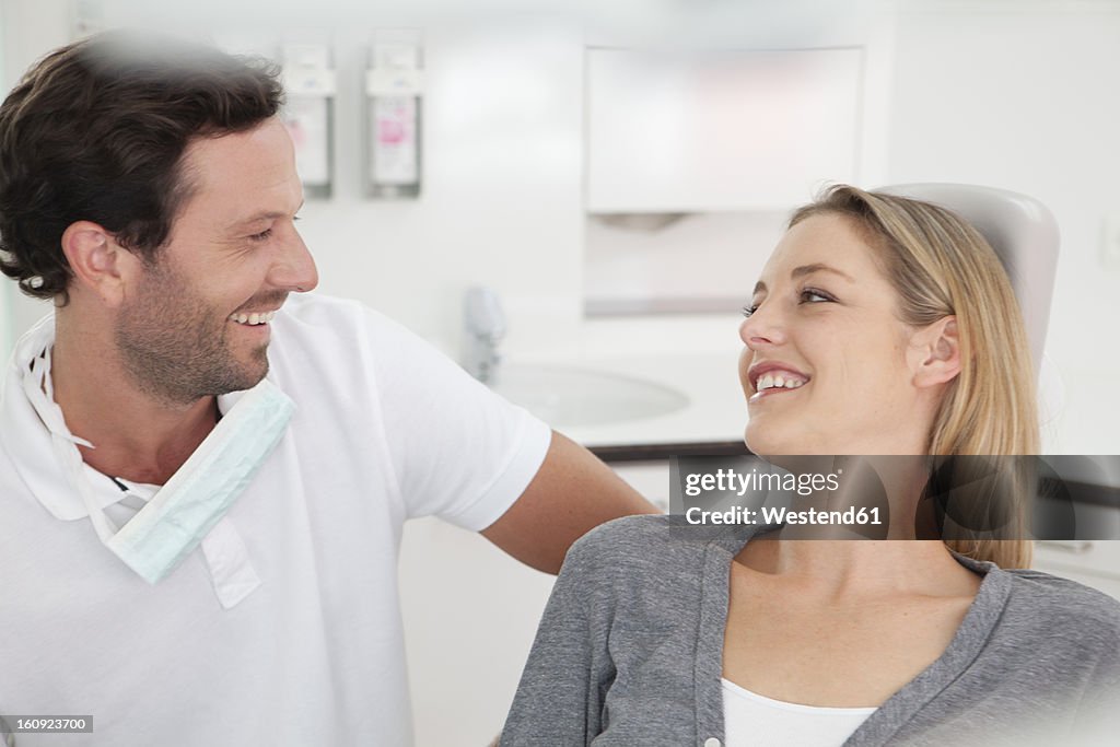 Germany, Dentist and patient in clinic, smiling