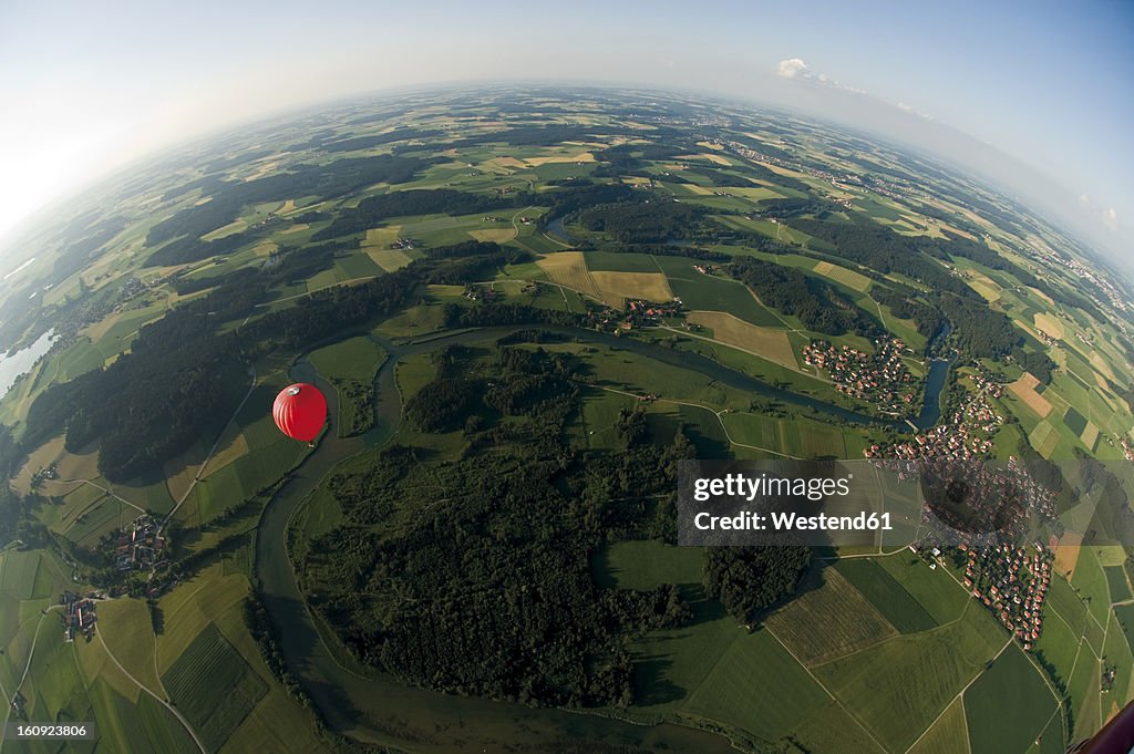 Germany, Bavaria, View of hot air balloon over pasture landscape