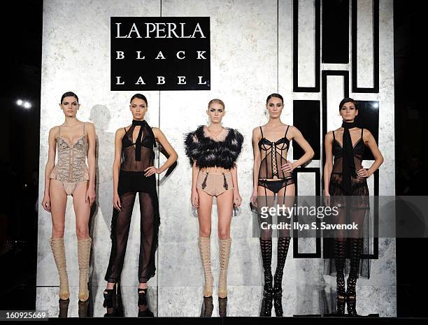 Models pose during the La Perla fall 2013 presentation during Mercedes-Benz Fashion Week at The Gallery at The Dream Downtown Hotel on February 7,...