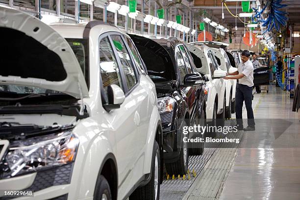 Mahindra & Mahindra Ltd. XUV 500 sport utility vehicles stand on the production line at the company's factory in Chakan, Maharashtra, India, on...