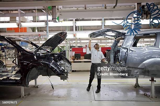 An employee works on the assembly line for the Mahindra & Mahindra Ltd. XUV 500 sport utility vehicle at the company's factory in Chakan,...