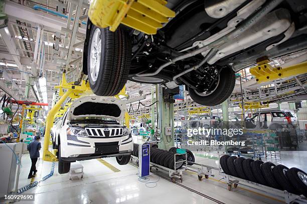 Vehicles move along the assembly line for the Mahindra & Mahindra Ltd. XUV 500 sport utility vehicle at the company's factory in Chakan, Maharashtra,...