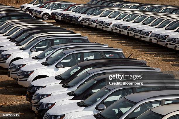 Rows of Mahindra & Mahindra Ltd. XUV 500 sport utility vehicles are parked in a stock yard at the company's factory in Chakan, Maharashtra, India, on...