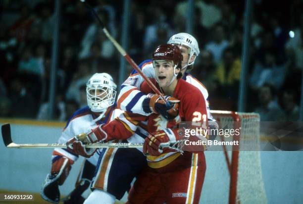 Perry Berezan of the Calgary Flames battles with Randy Gregg of the Edmonton Oilers during the 1986 Division Finals in April, 1986 at the Northlands...