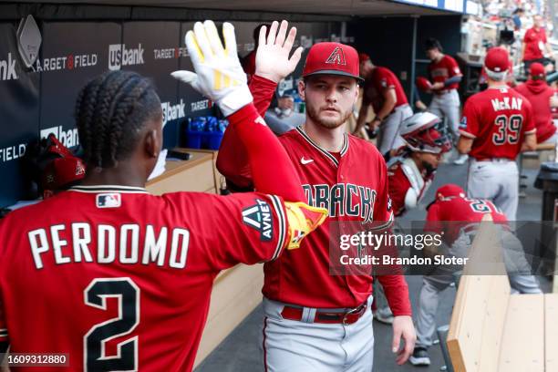 Ryne Nelson of the Arizona Diamondbacks high-fives Geraldo Perdomo prior to a game against the Minnesota Twins at Target Field on August 5, 2023 in...