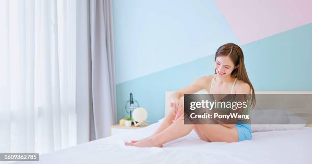 girl shaving leg hair - girl shaving legs stock pictures, royalty-free photos & images