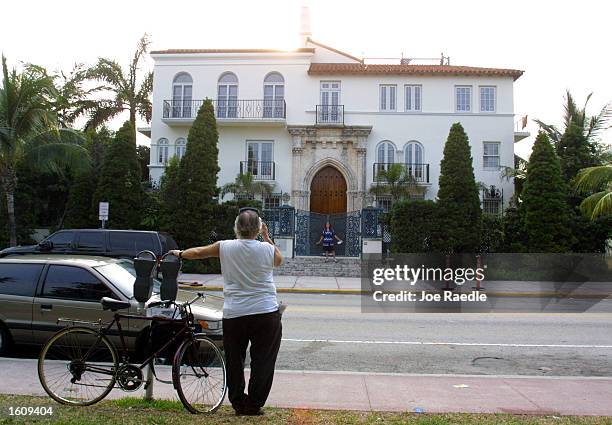 Tourist snaps a picture of Casa Casuarina, Gianni Versace''s former residence, August 15, 2001 in Miami Beach, Florida. South Beach''s most famous...