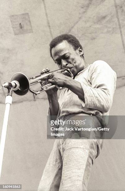 American jazz musician and composer Miles Davis , on trumpet, performs at the Schaefer Music Festival series at Wollman Rink, Central Park, New York,...