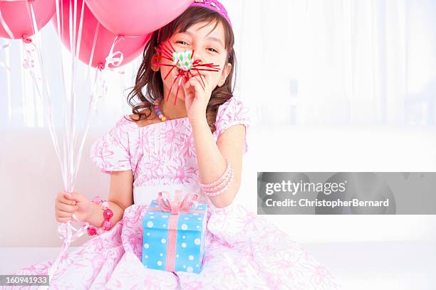 excited birthday girl playing with a party horn blower - party horn blower bildbanksfoton och bilder