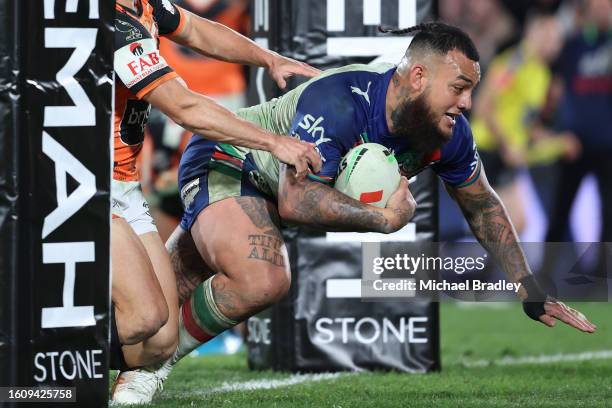Addin Fonua-Blake of the Warriors charges over for a try during the round 24 NRL match between the Warriors and the West Tigers at FMG Stadium...