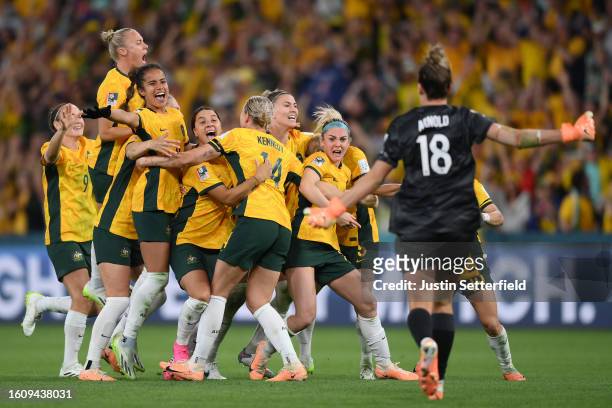 Players of Australia celebrate their side's victory in the penalty shoot out after Cortnee Vine of Australia scores her team's tenth penalty in the...