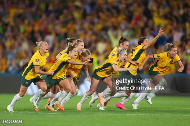 Players of Australia celebrate their side's victory in the penalty shoot out after Cortnee Vine of Australia scores her team's tenth penalty in the...