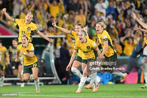 Players of Australia celebrate their side's victory in the penalty shoot out after Cortnee Vine of Australia scores her team's tenth penalty in the...