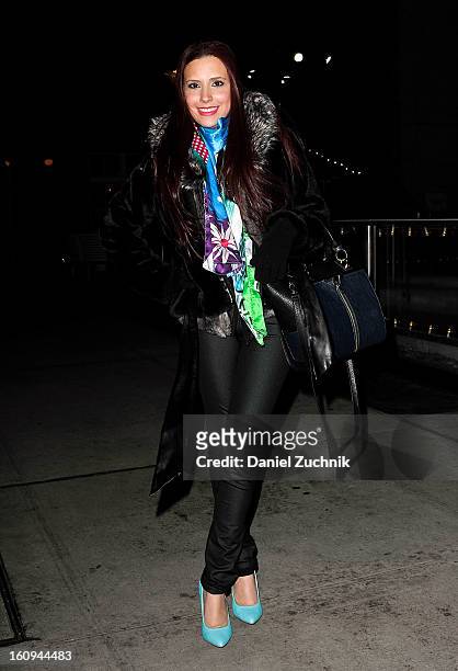 Diana 'Dee' Trillo, stylist/blogger from Miami, seen outside the Scoop party wearing a Guess fur coat, Custo Barcelona scarf, Danielle Nicole handbag...