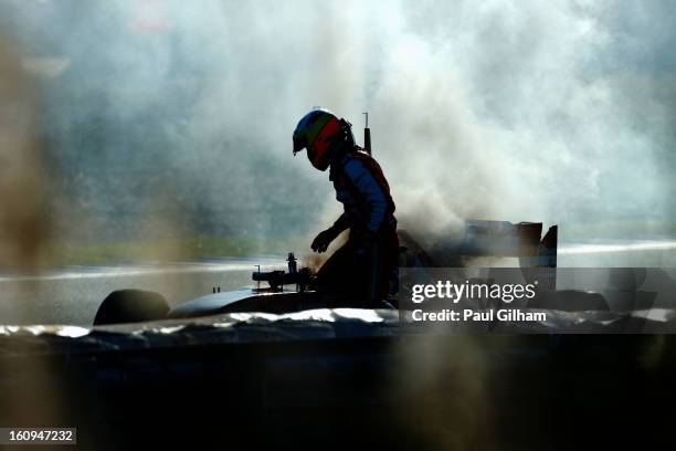 Pedro de la Rosa of Spain and Ferrari climbs out of his car after an engine failure during Formula One winter testing at Circuito de Jerez on...