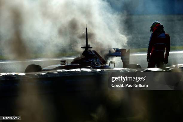 Pedro de la Rosa of Spain and Ferrari examines his car after an engine failure during Formula One winter testing at Circuito de Jerez on February 8,...