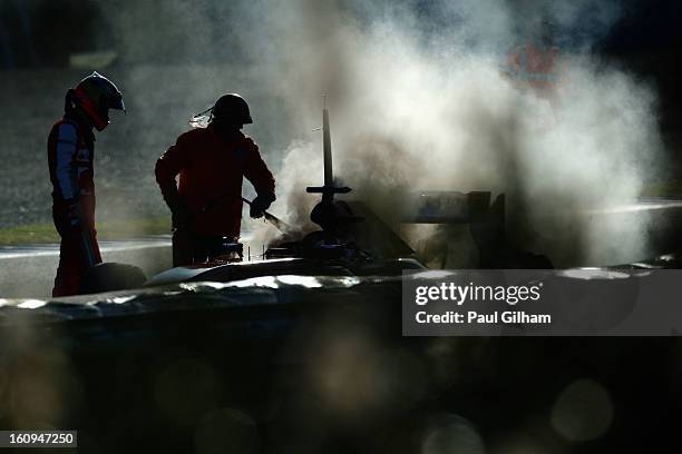 Pedro de la Rosa of Spain and Ferrari examines his car following an engine failure during Formula One winter testing at Circuito de Jerez on February...