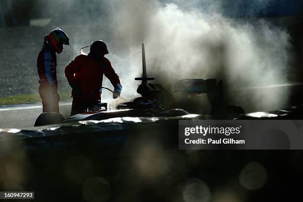 Pedro de la Rosa of Spain and Ferrari examines his car following an engine failure during Formula One winter testing at Circuito de Jerez on February...