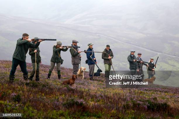 Members of a shooting party take aim as they mark the Glorious Twelfth, the annual start of the grouse shooting season on an estate in the Angus...