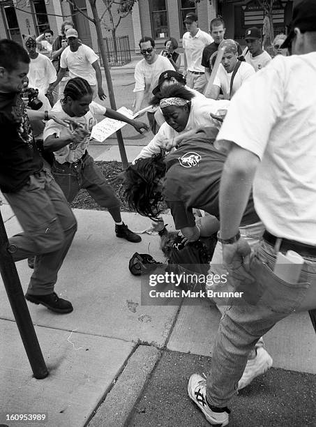 Protesters kick and punch the man down, he was saved by the woman in the white u.s.a. Sweatshirt. June 22, 1996. A dozen members of a self-anointed...