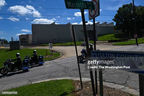 Sign for the Fulton County Jail is seen along Marietta Boulevard as law Enforcement officers ride their motorcycles on Wednesday, August 16, 2023 in...