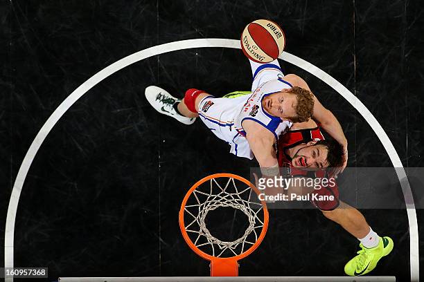 Luke Schenscher of the 36ers and Jeremiah Trueman of the Wildcats contest for a rebound during the round 18 NBL match between the Perth Wildcats and...