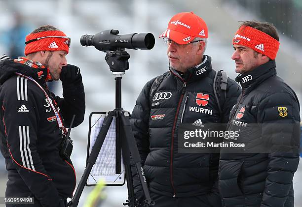 Uwe Muessiggang , head coach of Germany talks to assistant coach Mark Kirchner and team docotr Michael Koch during an offical training session during...