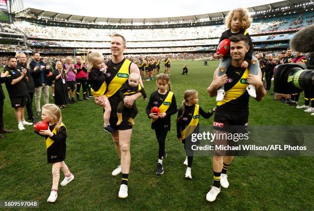 Jack Riewoldt of the Tigers and Trent Cotchin of the Tigers leave the field with their children after their final matches during the 2023 AFL Round...