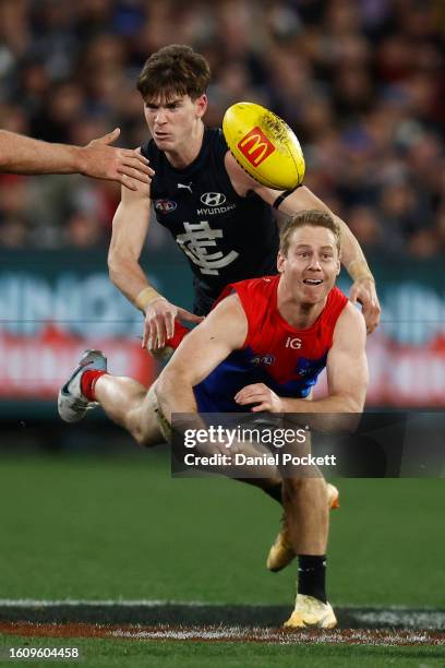 Lachie Hunter of the Demons handballs during the round 22 AFL match between Carlton Blues and Melbourne Demons at Melbourne Cricket Ground, on August...