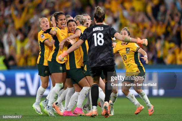 Players of Australia celebrate their side's victory in the penalty shoot out after Cortnee Vine of Australia scores her team's tenth penalty in the...