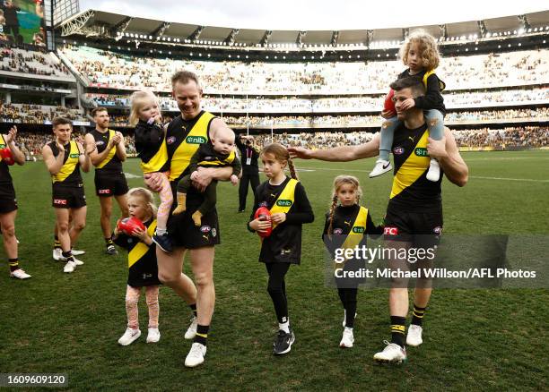 Jack Riewoldt of the Tigers and Trent Cotchin of the Tigers leave the field with their children after their final matches during the 2023 AFL Round...