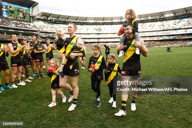 Jack Riewoldt of the Tigers and Trent Cotchin of the Tigers leave the field with their children after their final matches during the 2023 AFL Round...