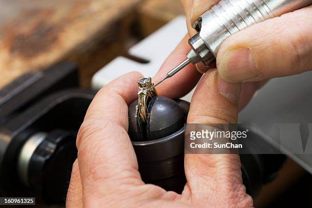 close up of a jeweler's hands doing a repair - diamond gemstone stock pictures, royalty-free photos & images