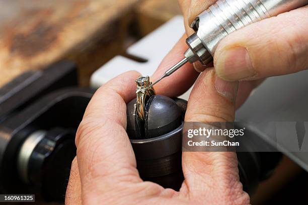 close up of a jeweler's hands doing a repair - platinum rings stock pictures, royalty-free photos & images