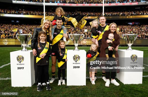 Jack Riewoldt of the Tigers and Trent Cotchin of the Tigers pose with the premiership cups with their wives and children after tier final matches...