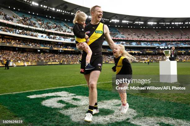 Jack Riewoldt of the Tigers completes a lap of honour with his daughters after his final match during the 2023 AFL Round 23 match between the...