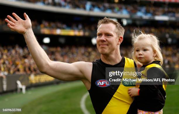 Jack Riewoldt of the Tigers completes a lap of honour with his daughter after his final match during the 2023 AFL Round 23 match between the Richmond...