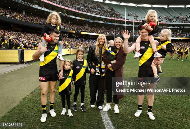 Jack Riewoldt of the Tigers and Trent Cotchin of the Tigers pose with their wives and children after their final matches during the 2023 AFL Round 23...