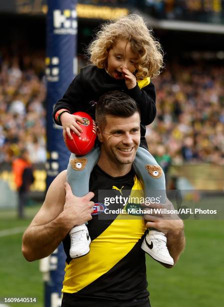 Trent Cotchin of the Tigers completes a lap of honour with son Parker after his final match during the 2023 AFL Round 23 match between the Richmond...