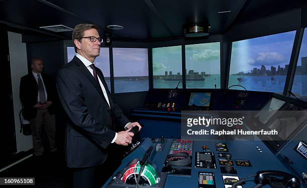 German Foreign Minister Guido Westerwelle is steering a ship in to the port of New York City, in the bridge simulator from the European Training and...