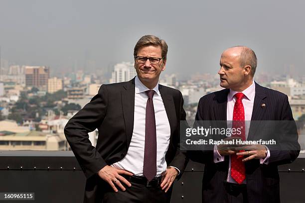 German Foreign Minister Guido Westerwelle and Cliff Davies , Praesident Doehle Philippines, on the roof of the Doehle Haus on February 8, 2013 in...