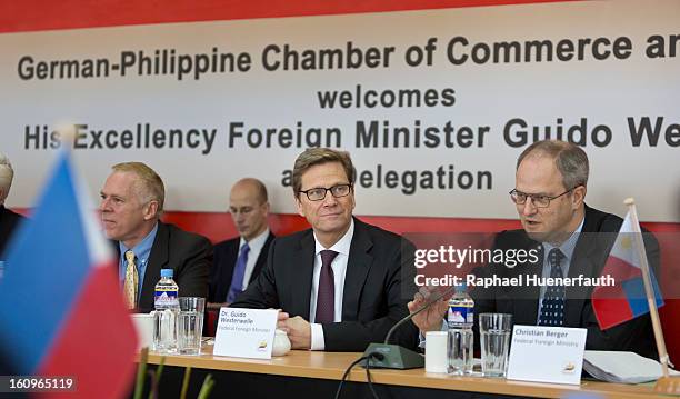 German Foreign Minister Guido Westerwelle takes part at the Economic Roundtable of the German-Philippine Chamber of Commerce and Trade , next to him...