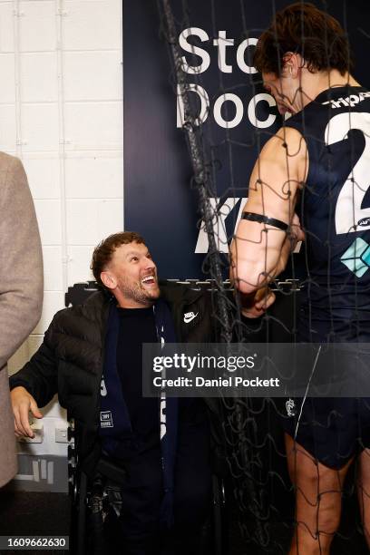 Dylan Alcott celebrates with Caleb Marchbank of the Blues after the round 22 AFL match between Carlton Blues and Melbourne Demons at Melbourne...