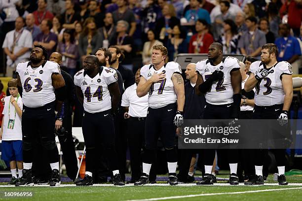 Bobbie Williams, Vonta Leach, Matt Birk, Kelechi Osemele and Marshal Yanda of the Baltimore Ravens stand for the performance of the National Anthem...